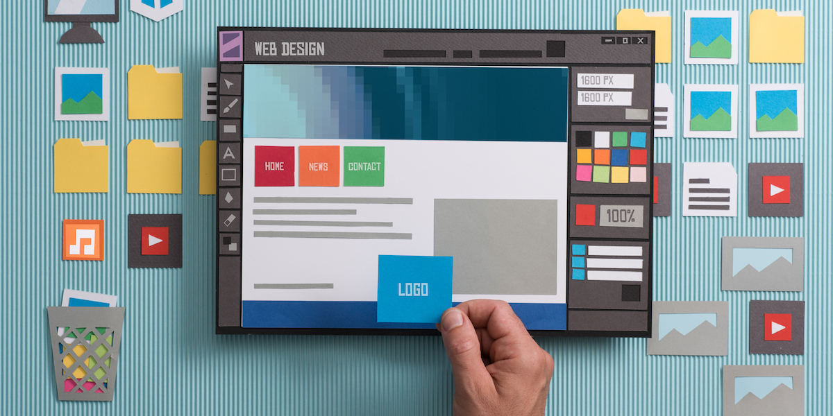 Web designer drafting web templates and web page layouts using a professional software, collage and paper cut composition
